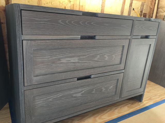 Dark-stained cabinet with drawers