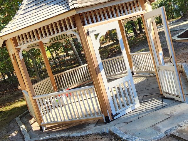Gazebo with a shingled roof and railings