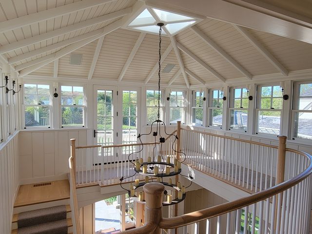Upper hall with a paneled ceiling and stair railing