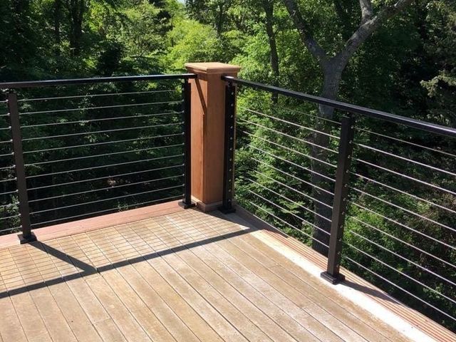 Deck corner with a wood post and cable railing