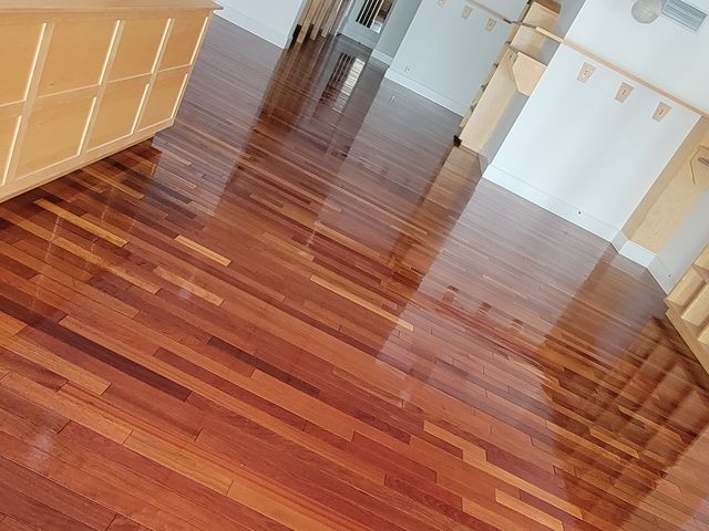 Finished wood floor near a kitchen