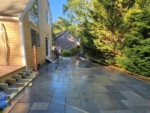 Finished bluestone patio and steps along the house