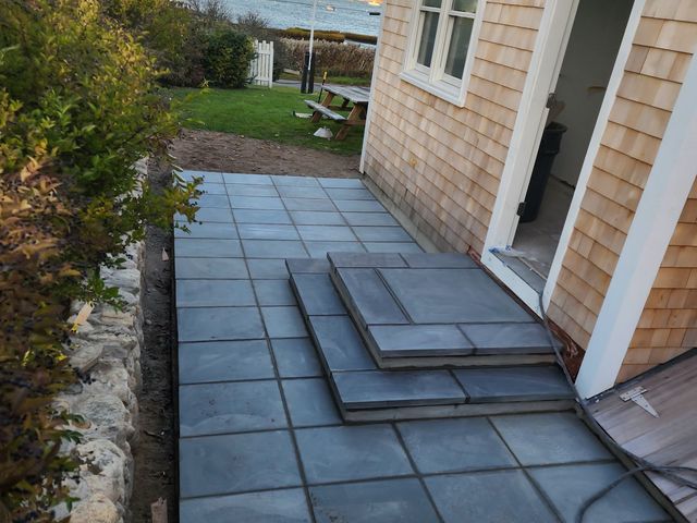 Bluestone patio along the shingled house