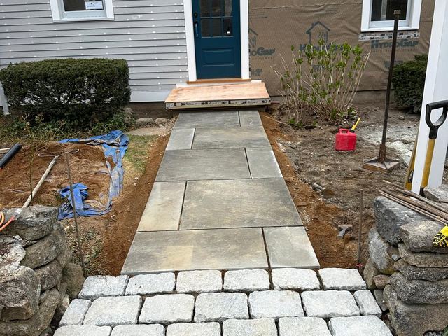 Bluestone walk with a granite cobblestone landing at the front of a house