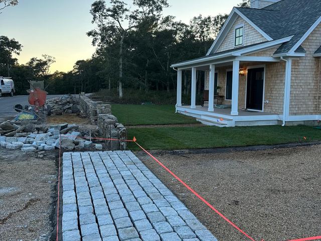 Granite cobblestone walkway with string lines for layout