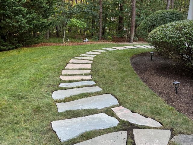 Natural flagstone stepping stone path curving through the lawn