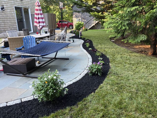 Curved planting bed by the patio