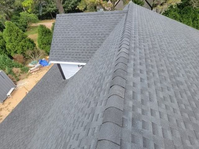 Asphalt shingle roof with trees behind