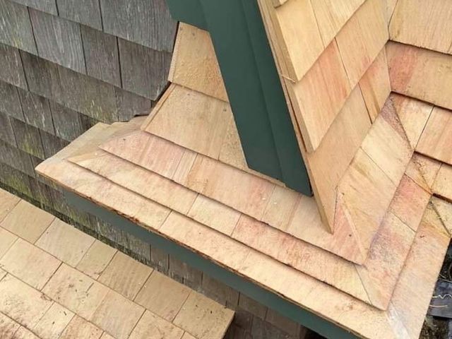 Wood shingle roof meeting a wall