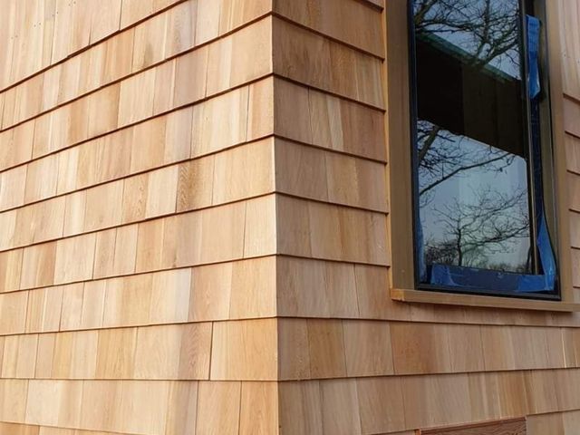 Wood shingle siding at a corner window