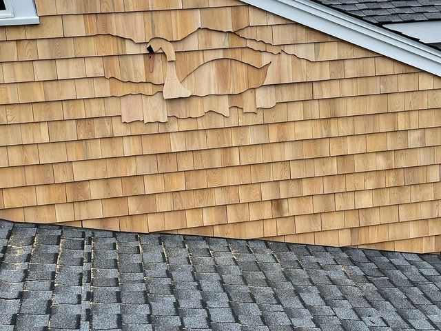 Shingle siding wall above a roof