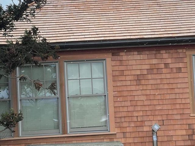 Shingled house wall with windows