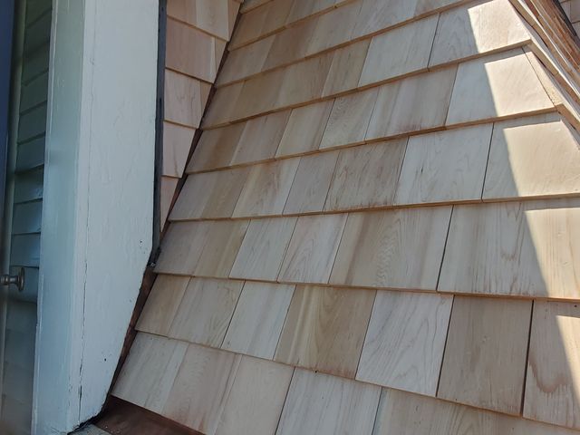 New wood shingles along a roof line