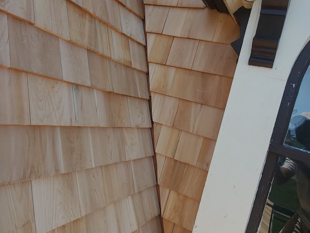 Wood shingles meeting window trim