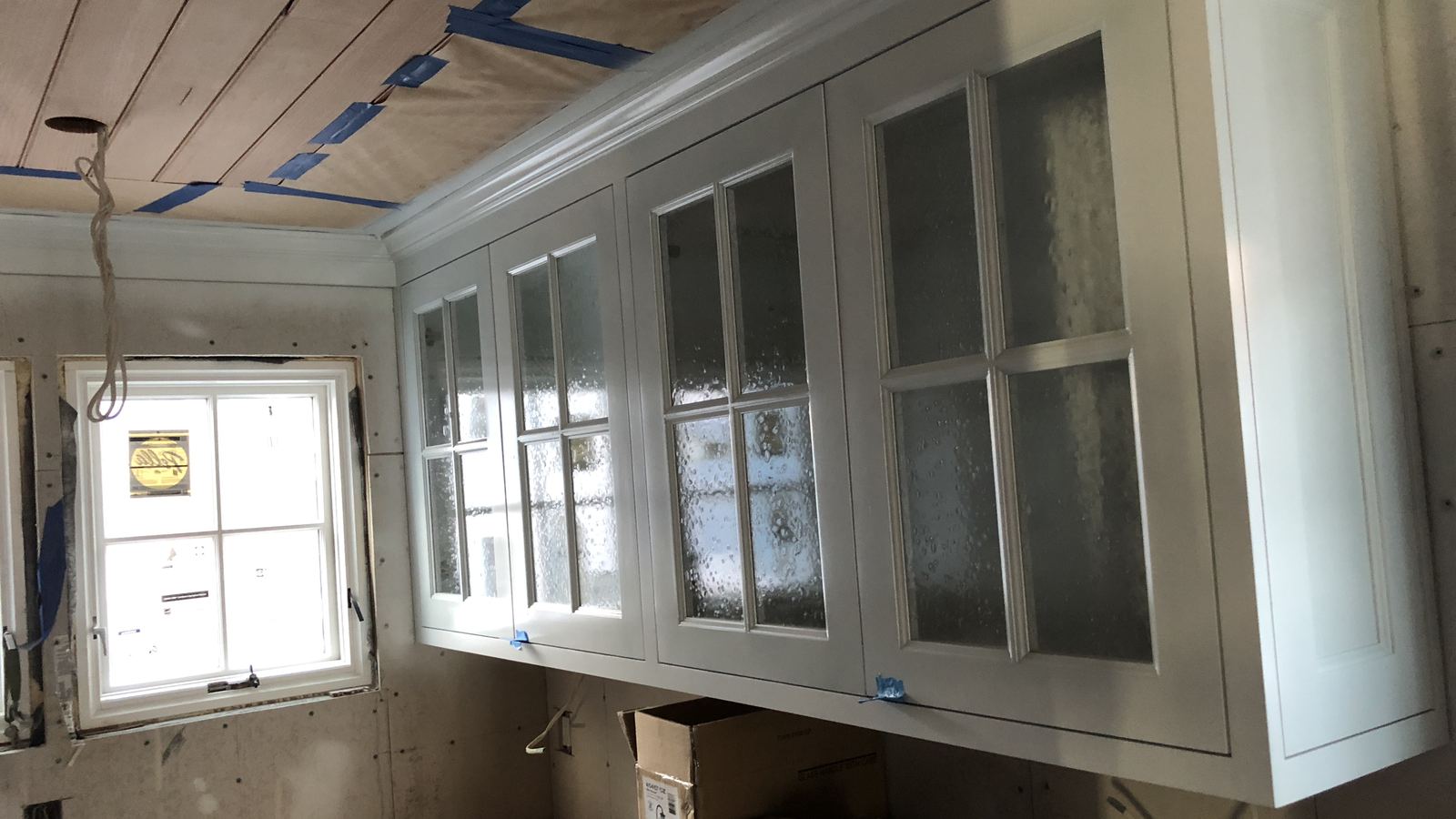 White upper cabinets with glass doors