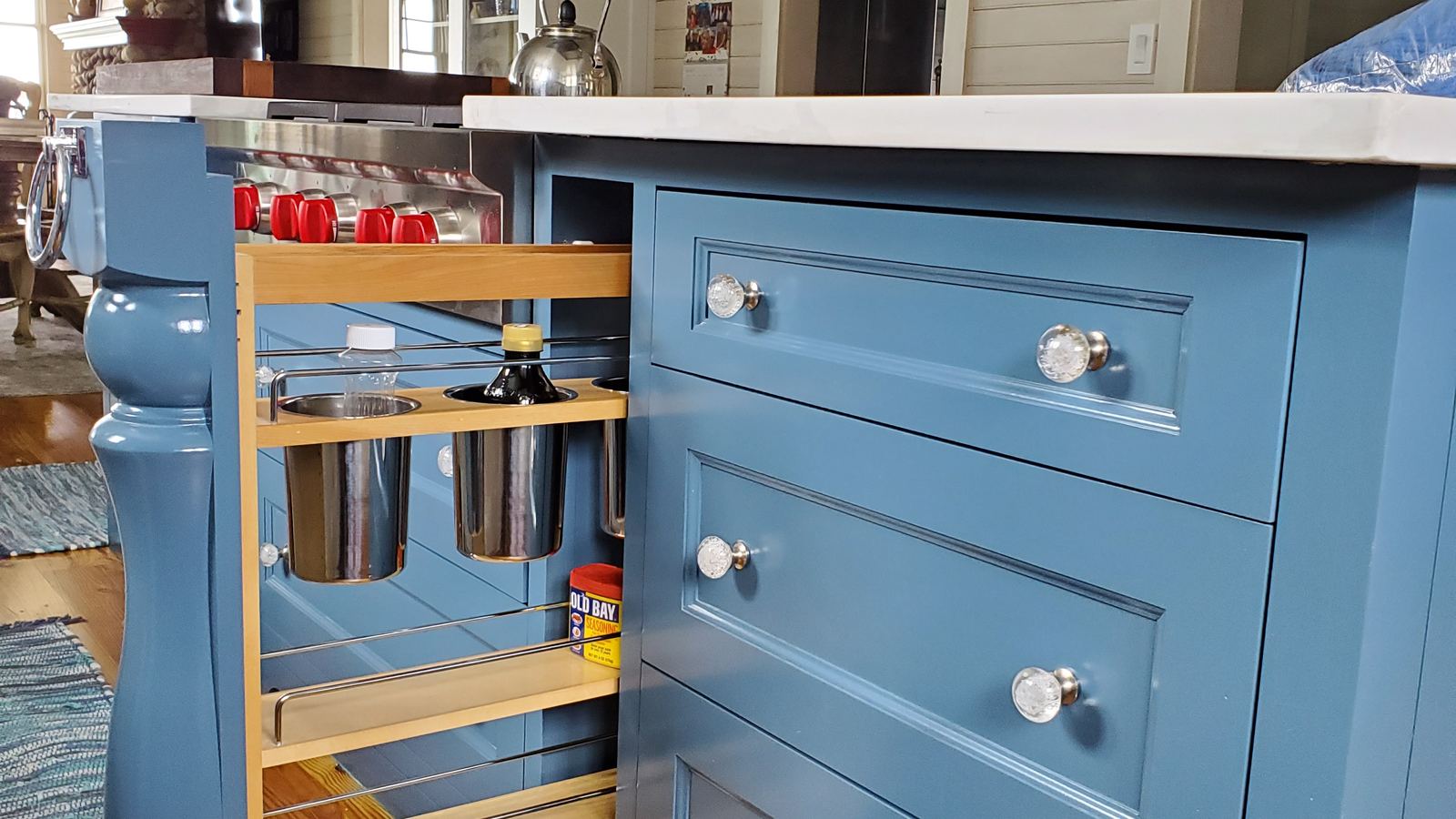 Blue kitchen island with a pull-out cabinet