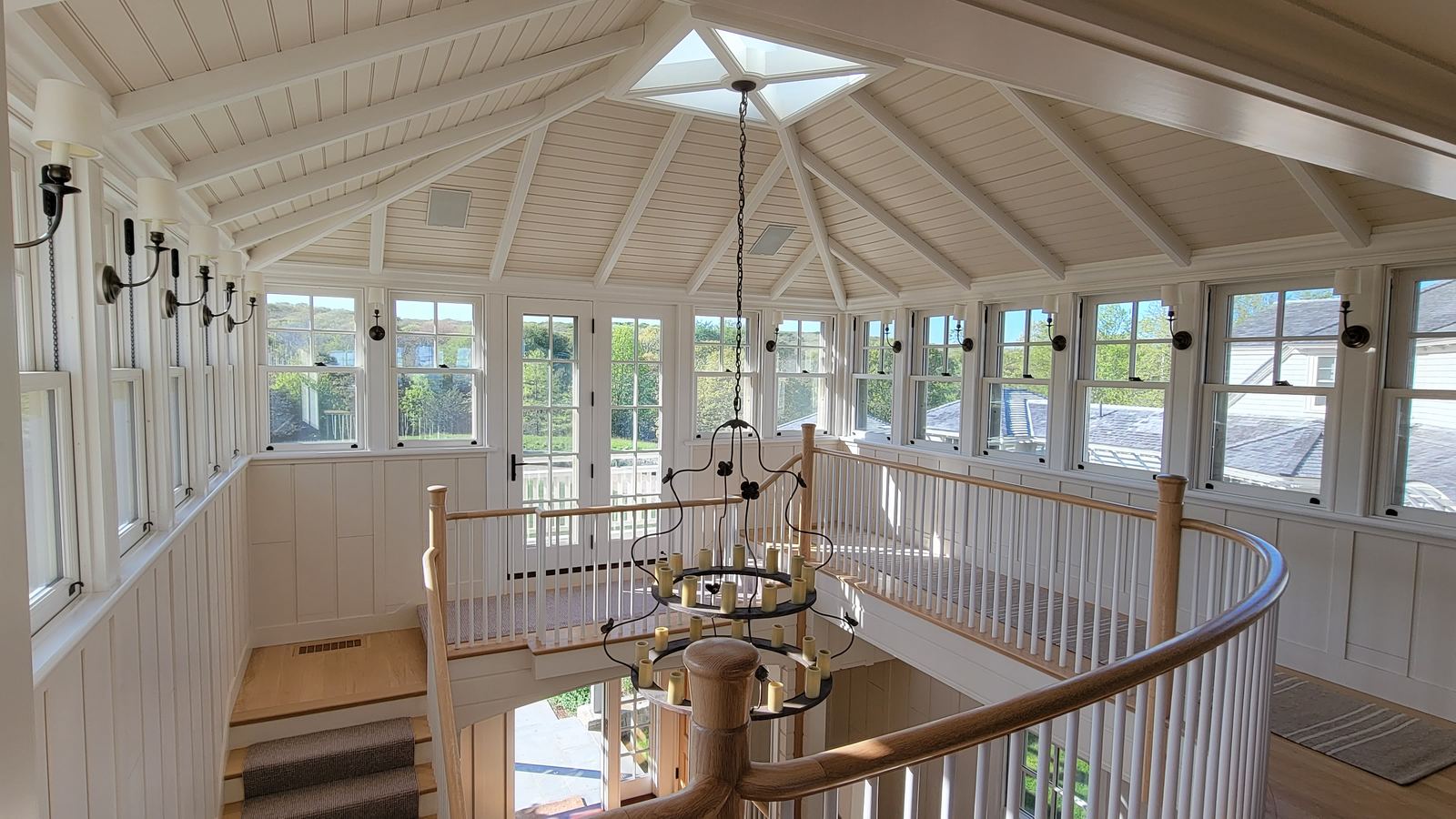 Upper hall with a paneled ceiling and stair railing