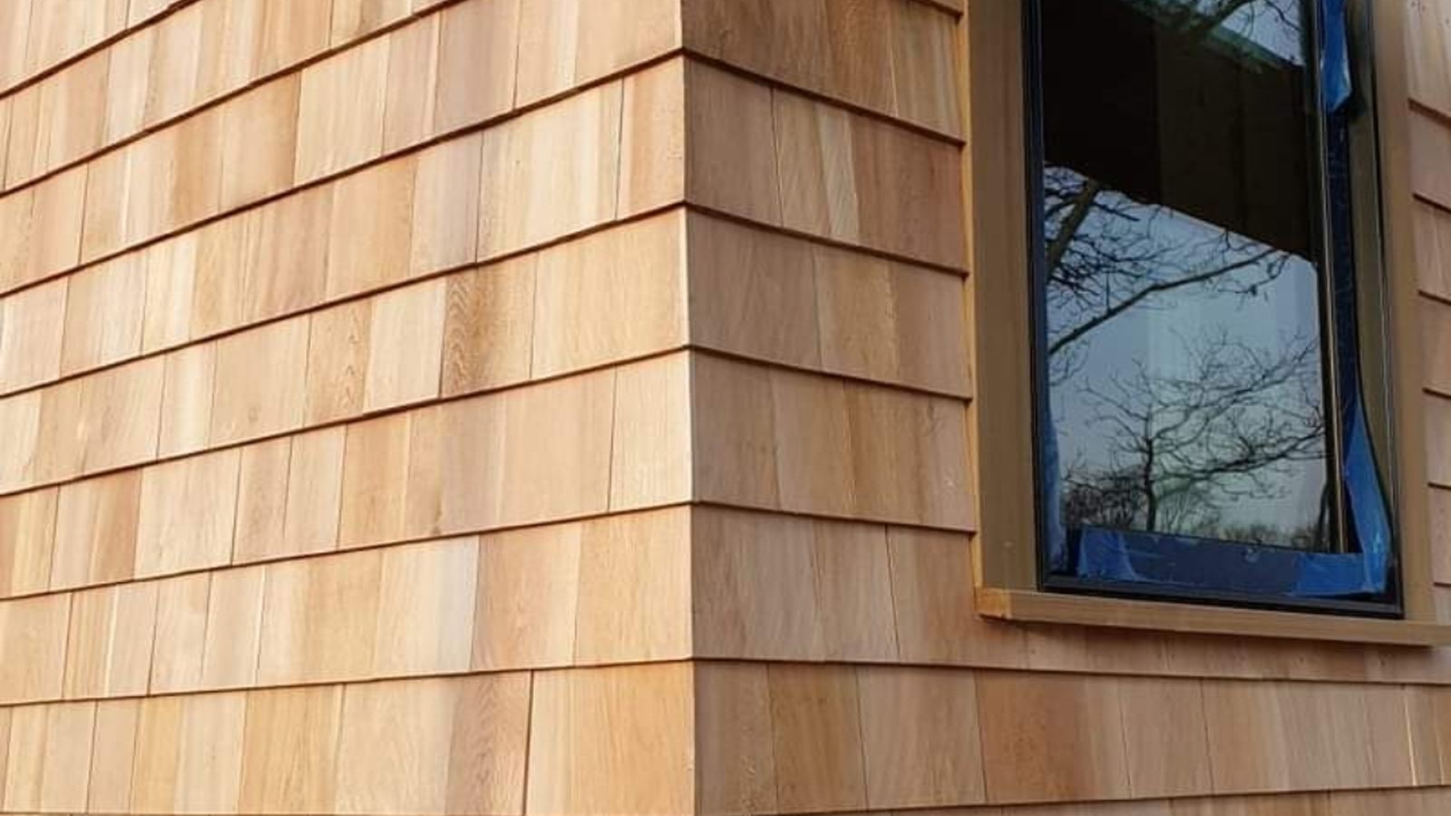 Wood shingle siding at a corner window